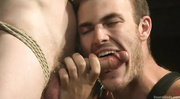 Tattooed master in leather pants enjoys humiliating his gay slave like a dog and flog him