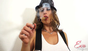 Big-titted MILF in a white vest, skirt and hat smoking a long cigar while seducing a dude