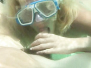 Blonde hooker with big tits in an underwater mask giving a deep throat in the pool