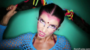 Hot chick with colorful make up displays her stunning body in shiney purple lingerie under her blue fishnet dress then pulls down a horny dude's shorts and swallows his dick til it unleashes warm spunk in her mouth.