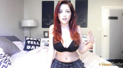 Perfect hussy in a striped skirt, black top and bra does the Rubik’s cube topless in bed.